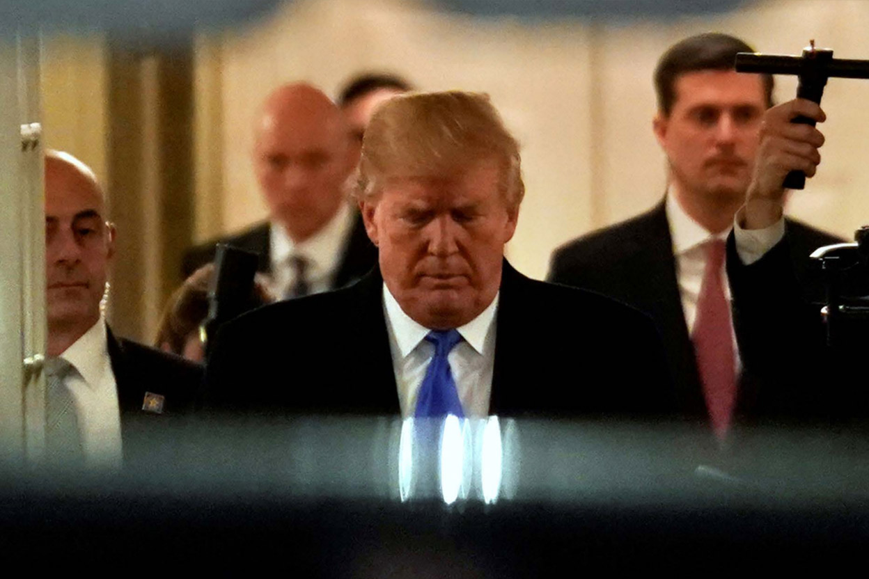 Former President Trump slips into a private car in the wee hours of the morning.